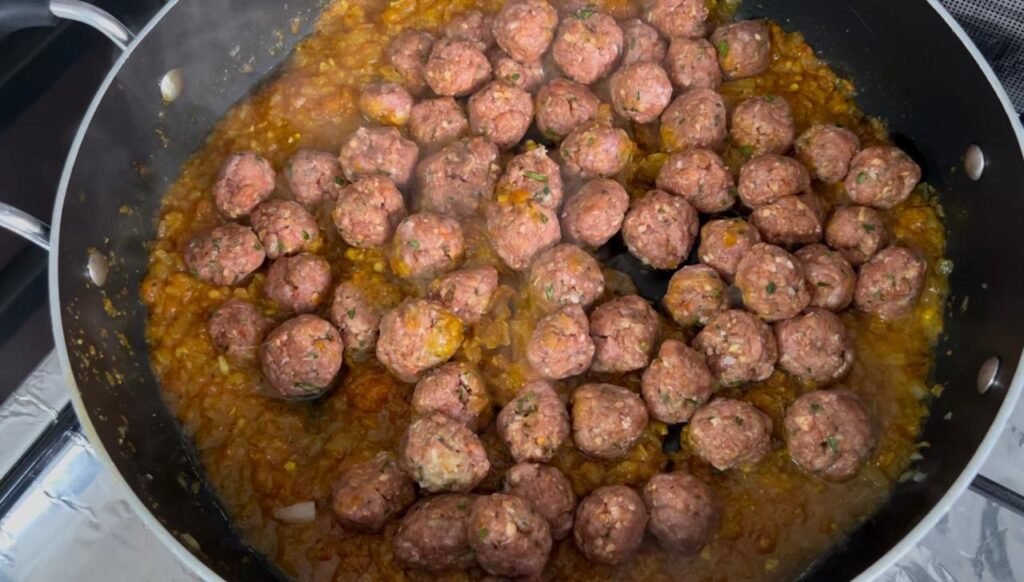 Raw meatballs ready to add to easy meatball and potato stew