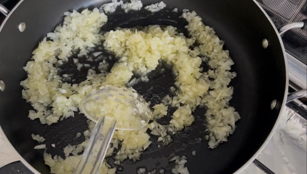 Translucent sautéed onions and garlic for easy meatball and potato stew base
