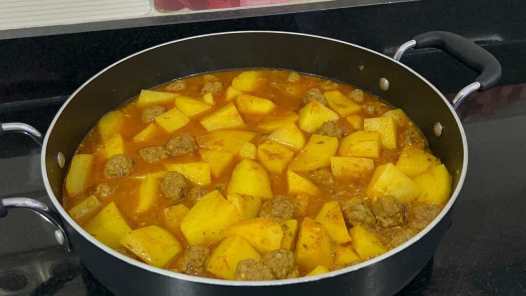 Easy meatball and potato stew plated showing meatballs, potatoes, and rich sauce