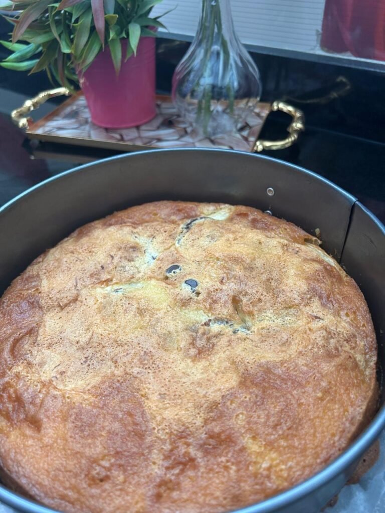Golden baked easy peach cake showing caramelized peaches and chocolate chips